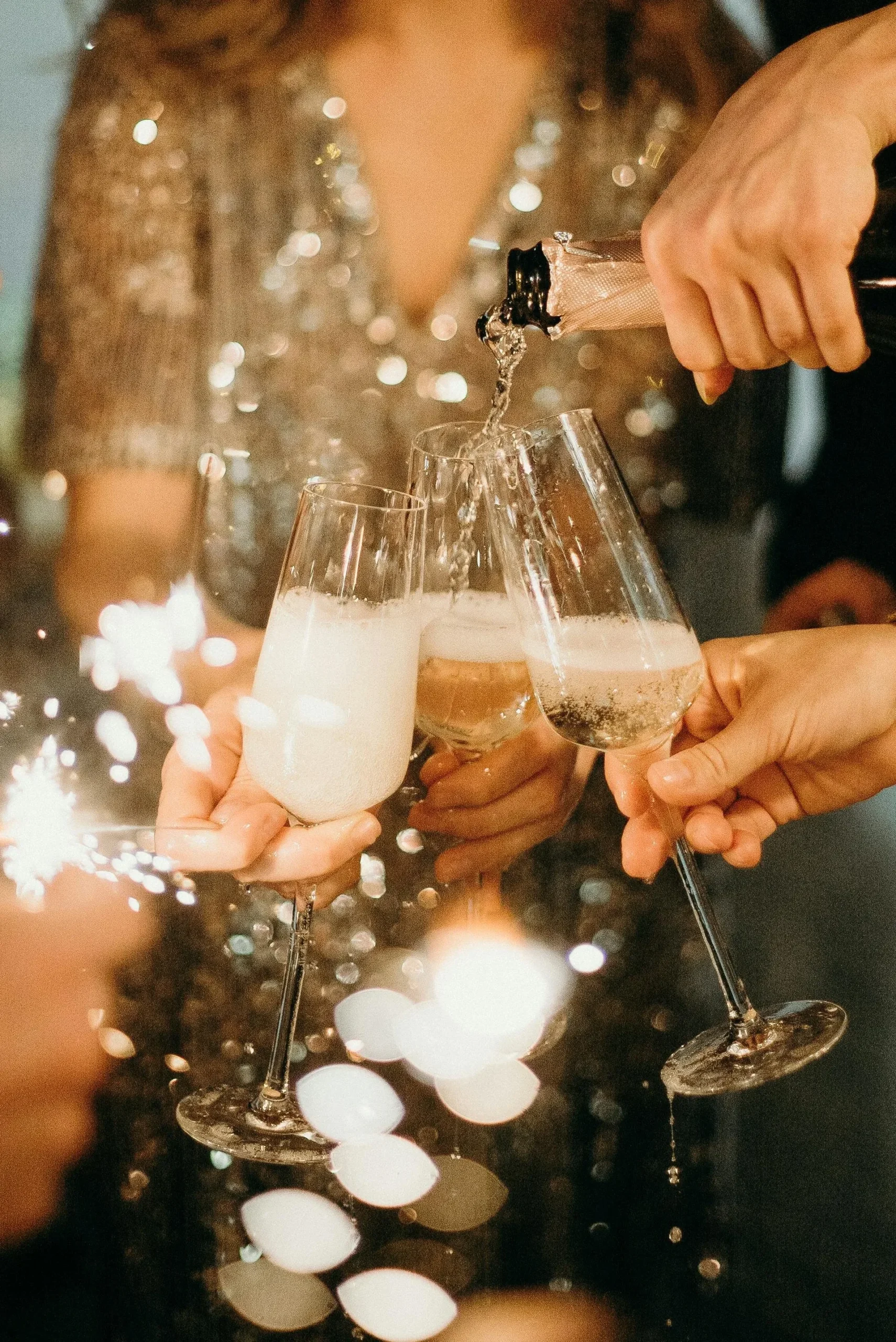 Brindis de fiesta con copas y vestidos brillantes