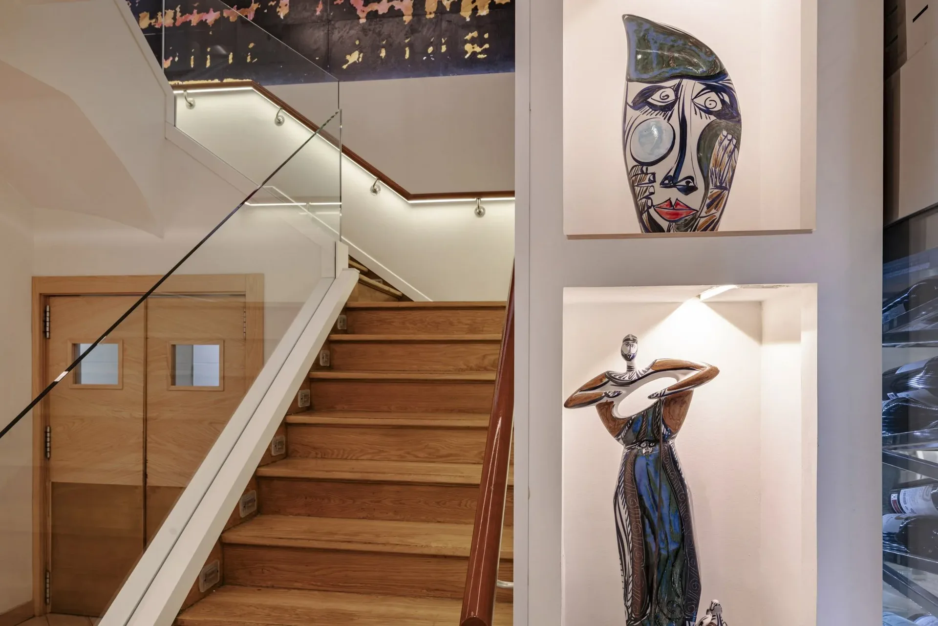 Wooden staircase and decorative sculptures inside Ogrelo