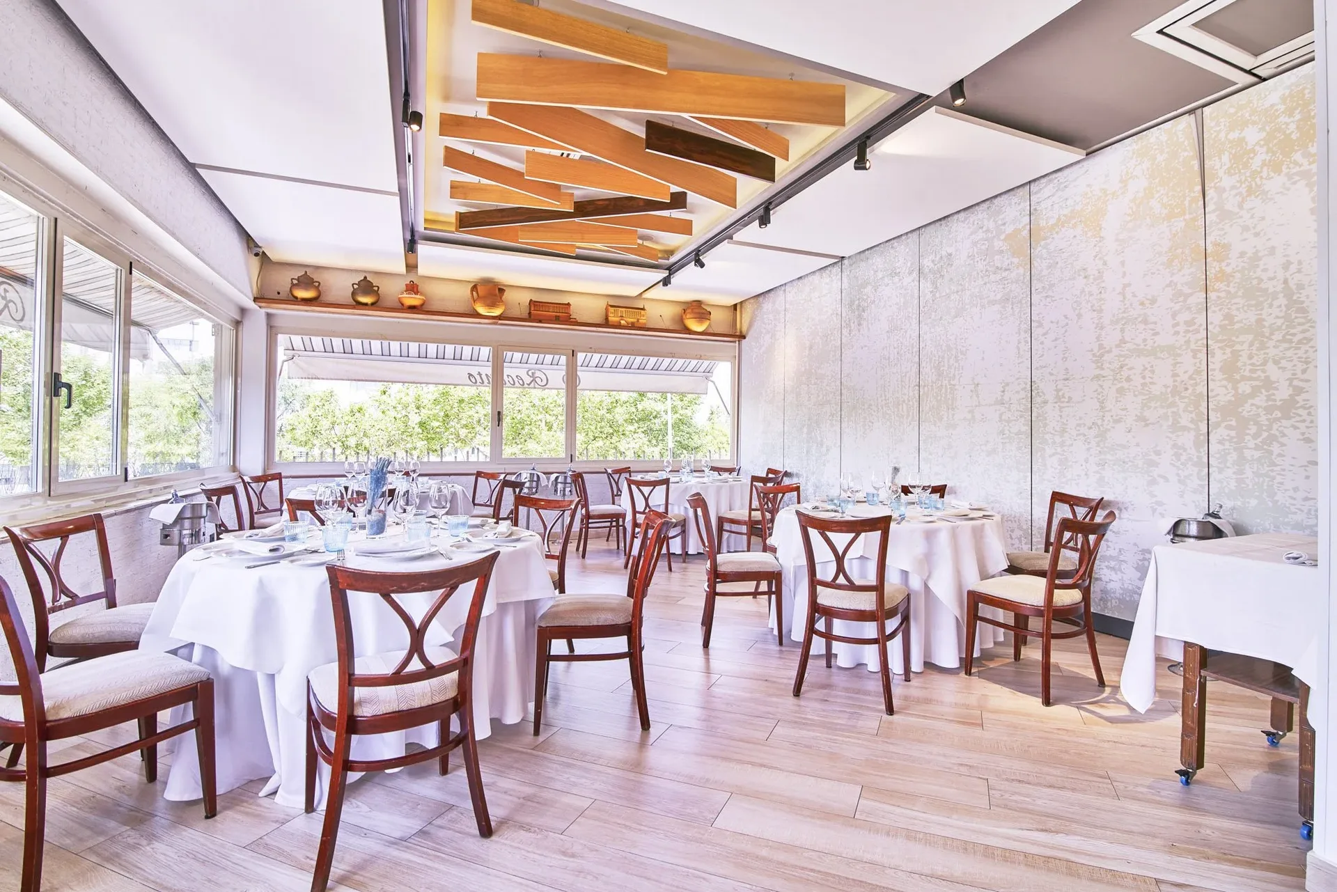 Room with a wooden ceiling and round tables